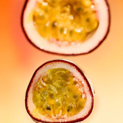 Close-up of a halved passionfruit on a warm-toned background
